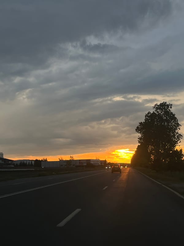Dramatic sunset captured on Bulgarian road amid stormy skies