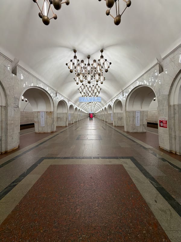 Ornate subway station hall with bronze chandeliers documented
