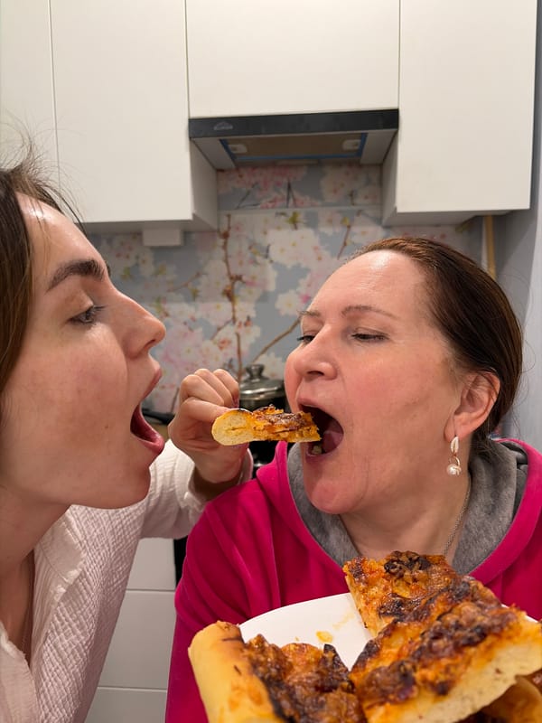 Women share homemade meal in Neftekamsk kitchen