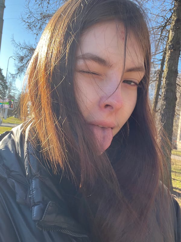 Woman takes playful selfies on Saint Petersburg street