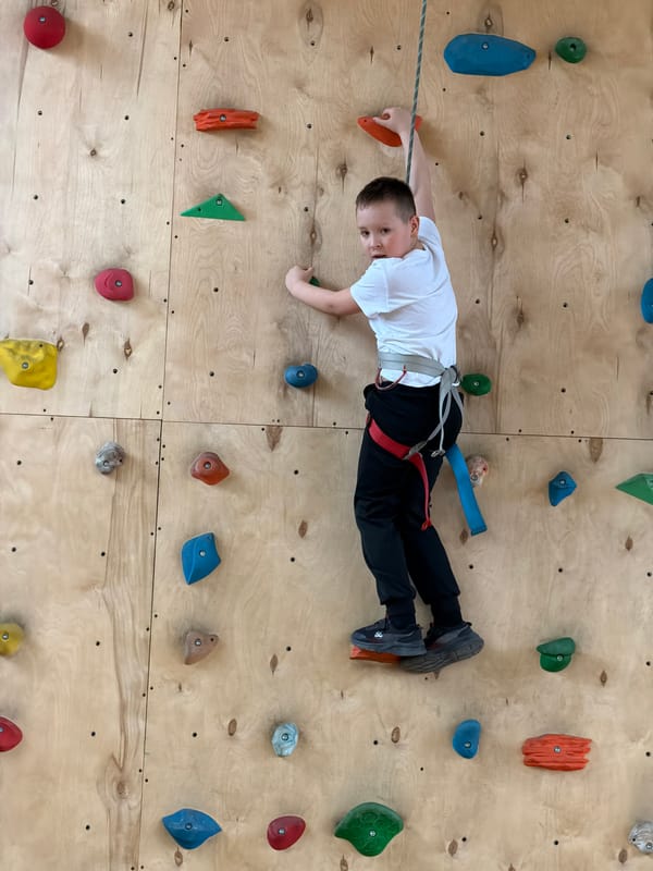 Young girl rock climbing at indoor facility in Izhevsk