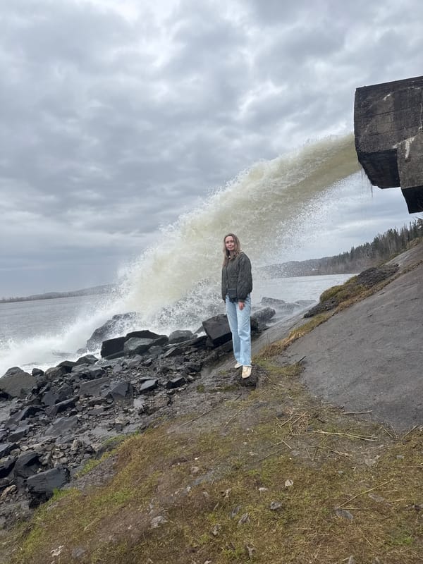Woman poses by waterfall in Chernushka, Russia
