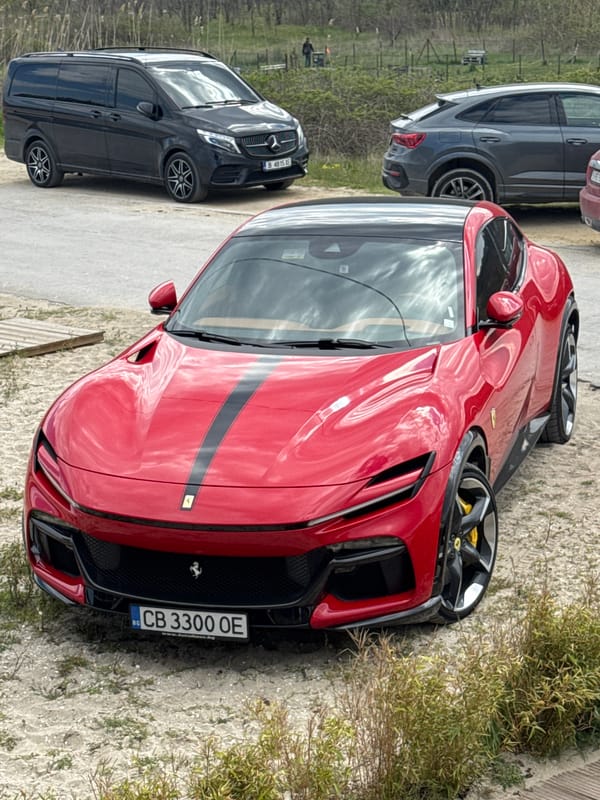 Red Ferrari parks alongside dirt path in Varna