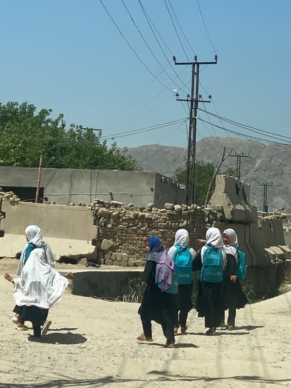 Young girls with UNICEF backpacks walk Kandahar streets