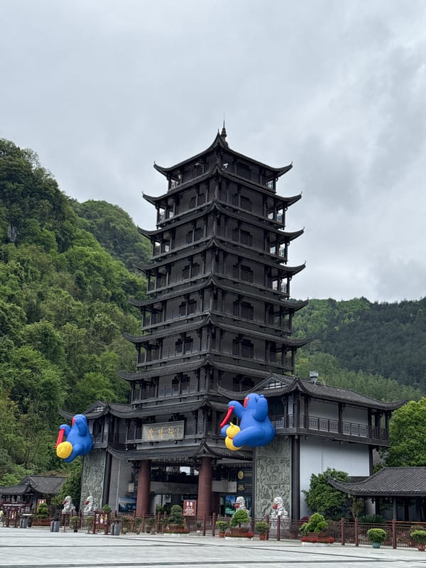 Traditional pagoda documented in Wulingyuan amid green hills