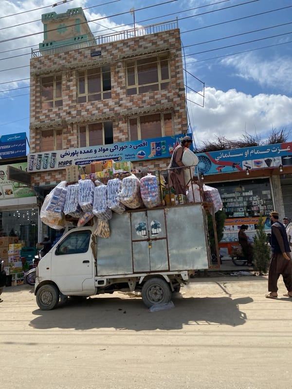 Morning commerce unfolds on Kandahar streets with vendors, trucks