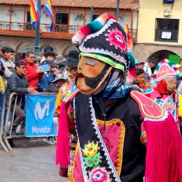 Costumed parade and traditional dancing in Cuzco's historic streets