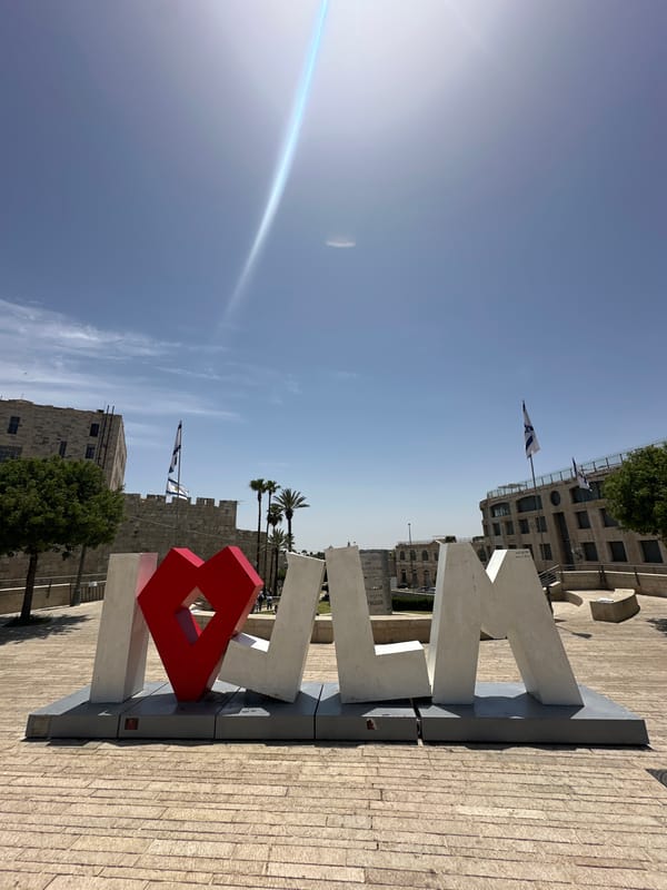 Young men gather with Israeli flags near Western Wall