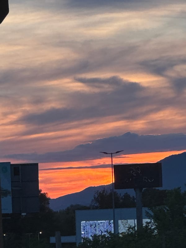 Sunset observed over Budva, Montenegro with orange cloud reflections