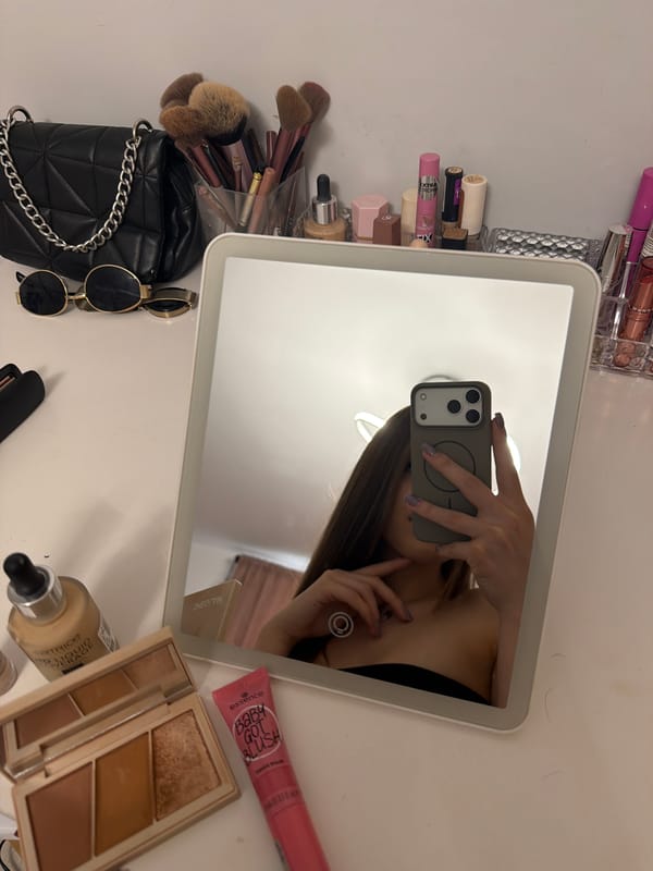 Person takes mirror selfie at vanity table in Shumen