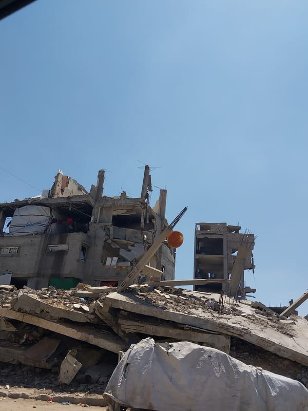 Damaged building with exposed rebar documented in Gaza