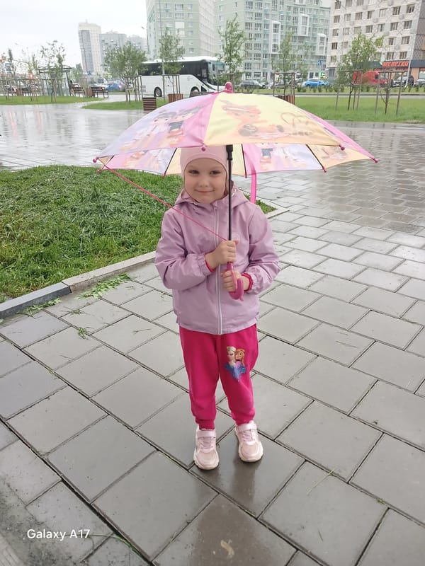 Girl with umbrella spotted on wet Yekaterinburg street
