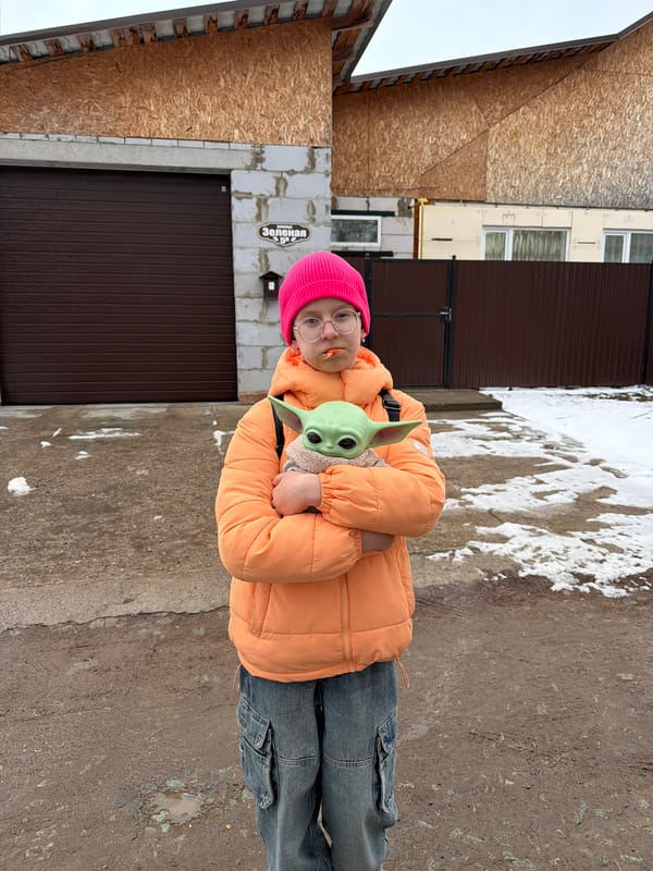 Friends pose with Baby Yoda doll in Chaikovsky