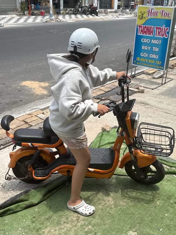 Morning scooter activity on a Phú Thủy street