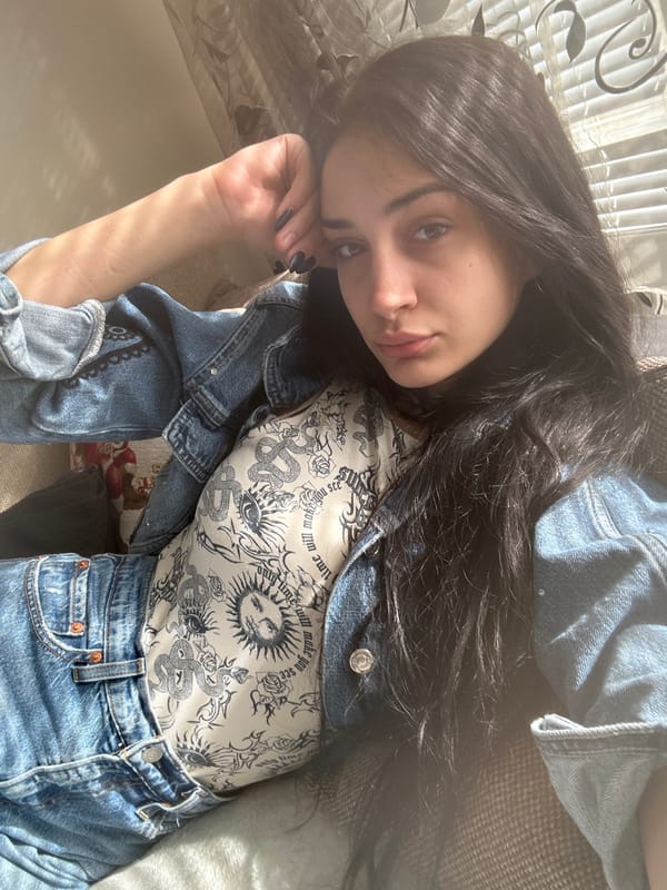 Woman rests on sofa in sunlit Burgas apartment