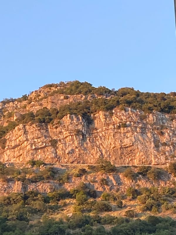 Summer evening light across Budva's streets, hills, and coastline