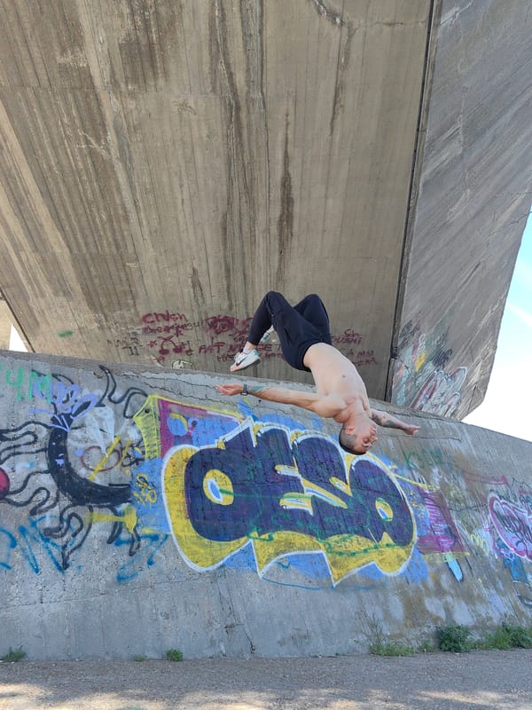 Tattooed athlete performs acrobatic stunts near Varna bridge