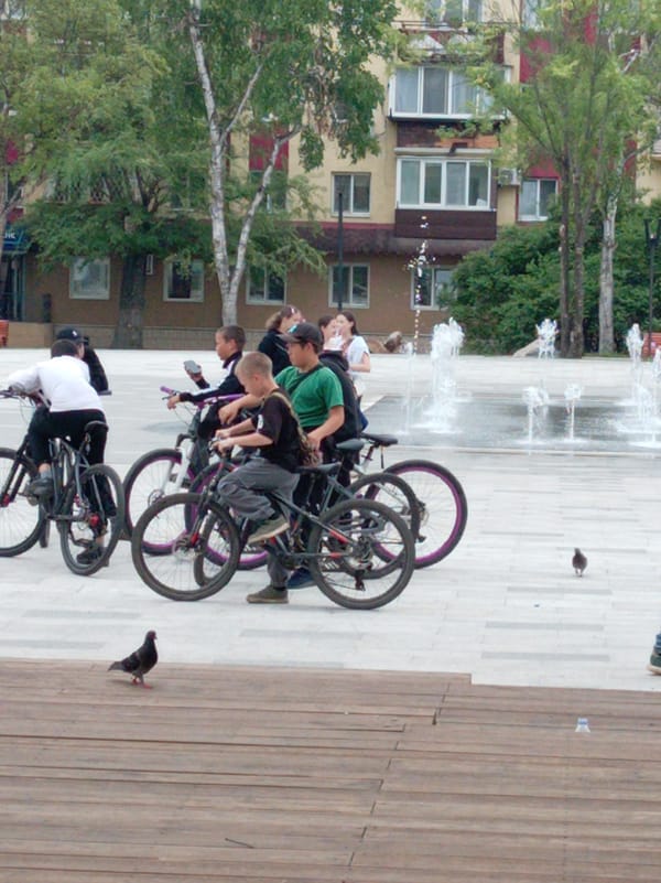 Young cyclists gather at fountain in Artyom square