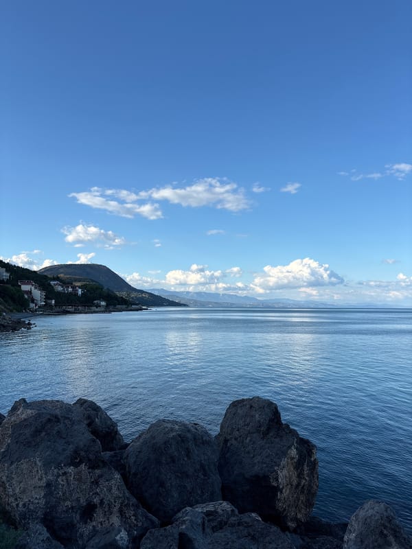 Rocky Crimean shoreline under a clear summer sky