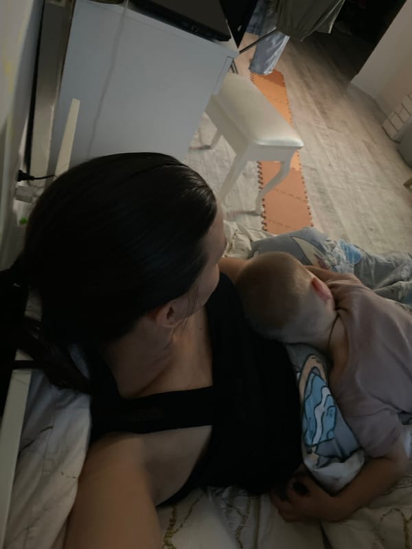 Adult and child share quiet bedroom moment with teddy bear