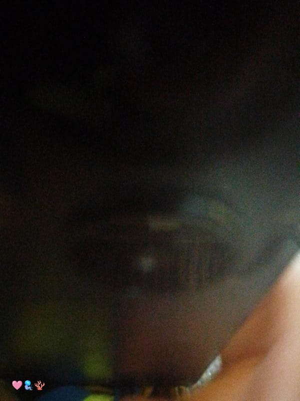 Woman takes selfie, blurry hand photo captured simultaneously indoors