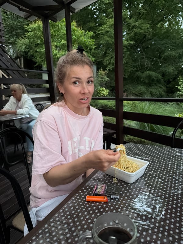 Woman eating noodles outdoors captured in Sochi