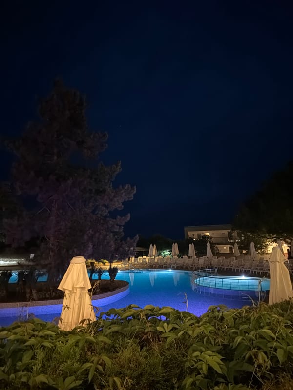 Evening resort documentation captures illuminated pools and dining in Primorsko