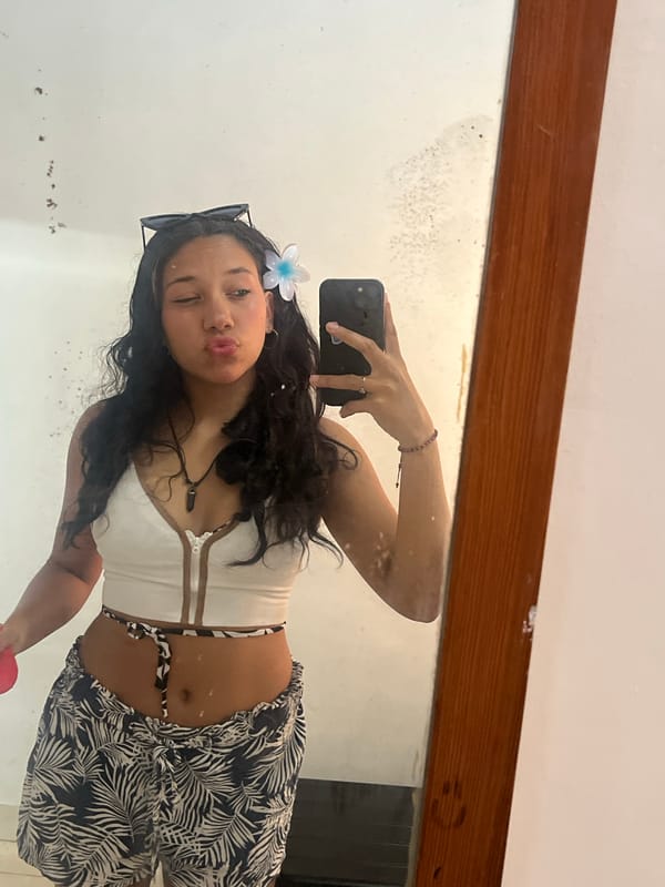 Woman takes selfies with chocolate bar in Pampatar, Venezuela