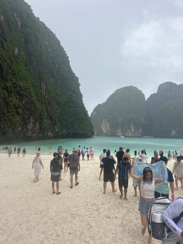 Rainy day at Ao Nang beach, karsts, warning flags, and wet trails