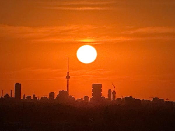 Berlin skyline glows under a wide summer sunset