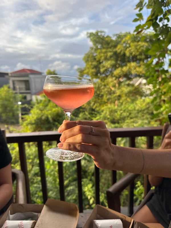 Casual patio lunch with pink cocktails documented in Kuta Selatan
