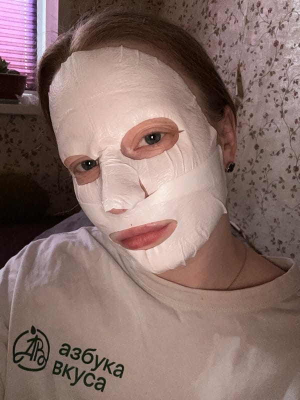 Moscow resident uses facial mask while wearing grocery store shirt