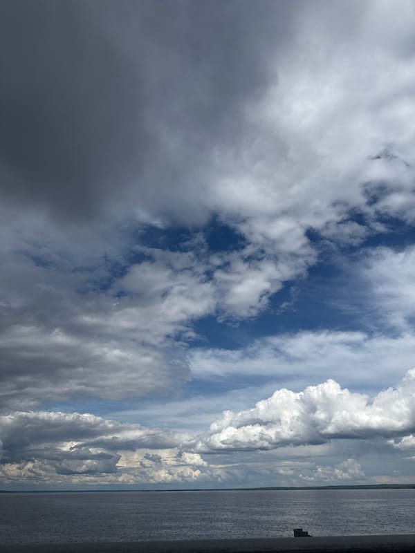 Contrasting cloud formations observed over water in Chaikovsky, Russia