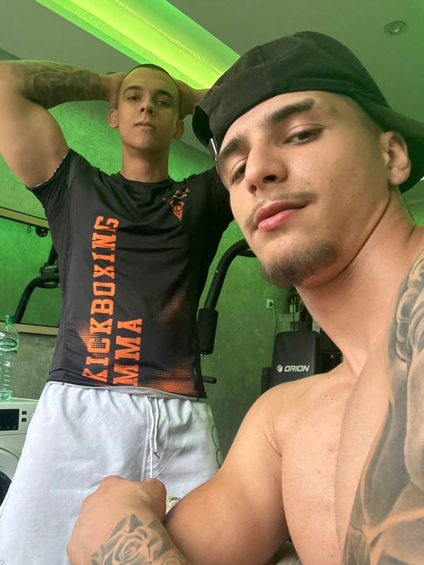 Two men documented during gym workout session with weights