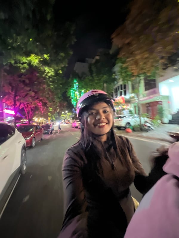 Late-night motorcycle selfies on wet streets in Minh Xuân Ward