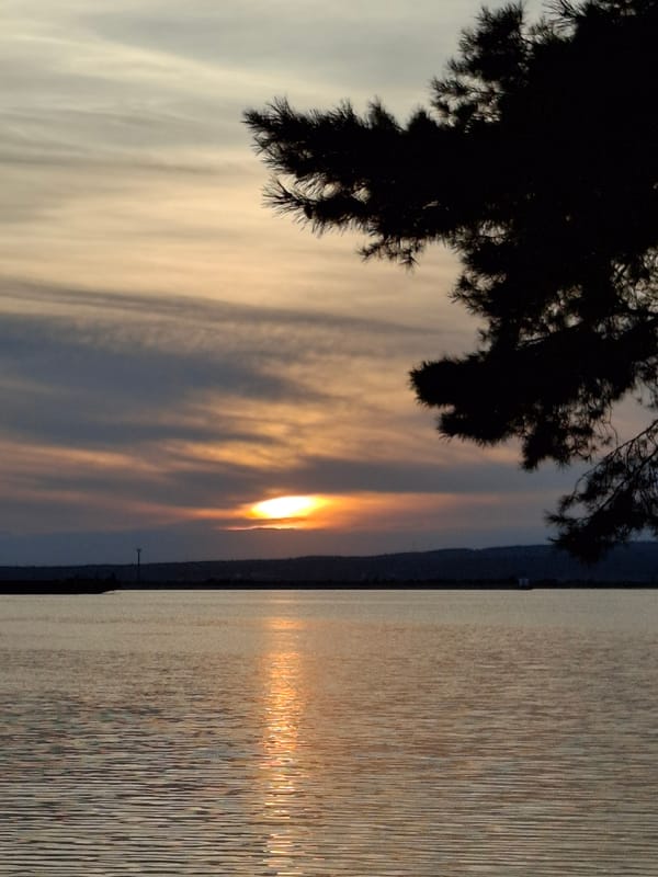 Sunset on the Kama River, Chaikovsky, with a speedboat passing through.