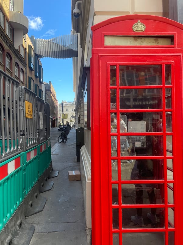 Sunny morning around a red phone box in Covent Garden