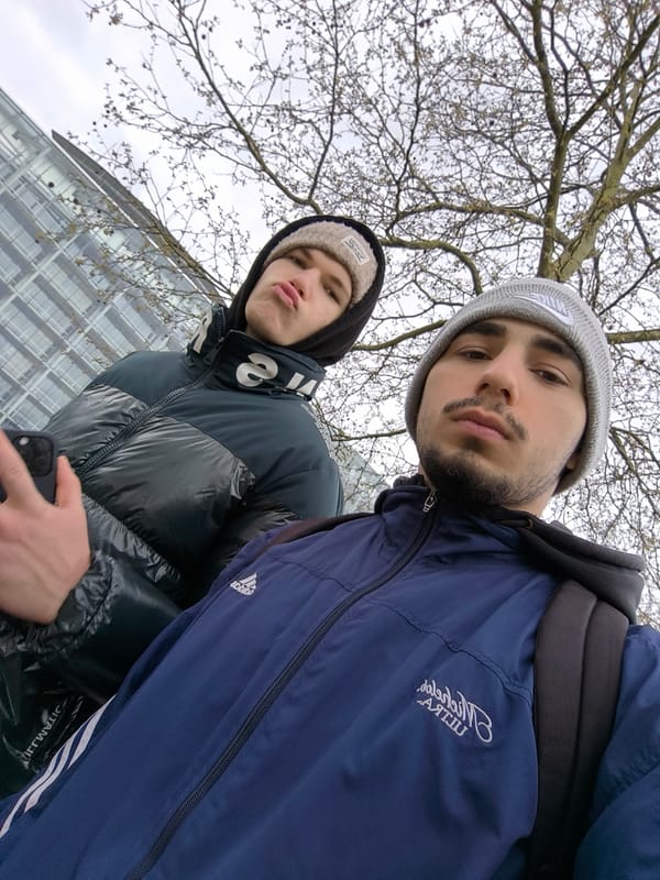 Young men take selfies outdoors in Strasbourg