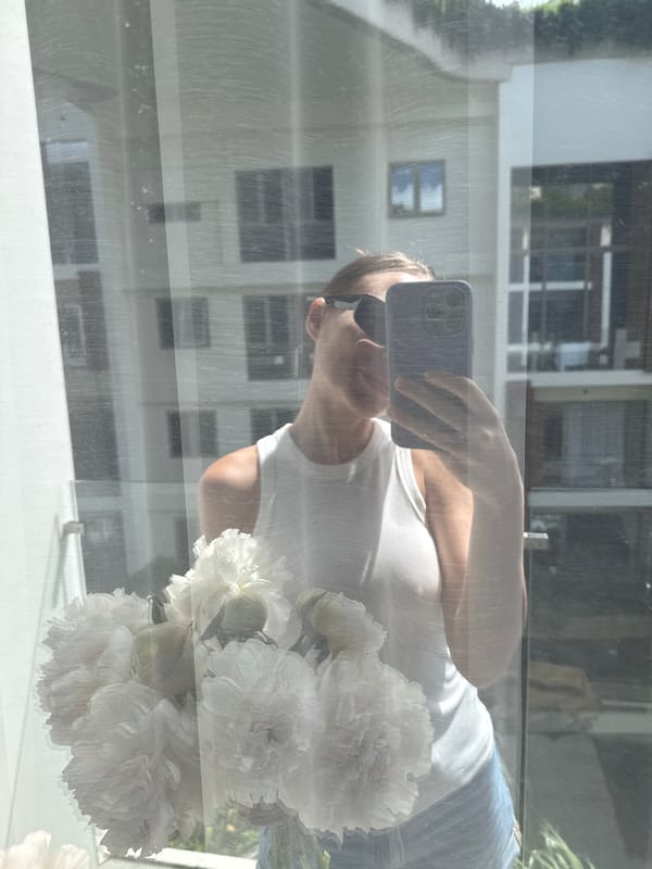 Woman with peony bouquet photographed taking selfie in Thailand