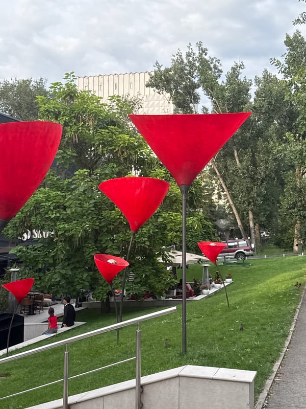 Strolling a stylish Almaty promenade past public art and cafés