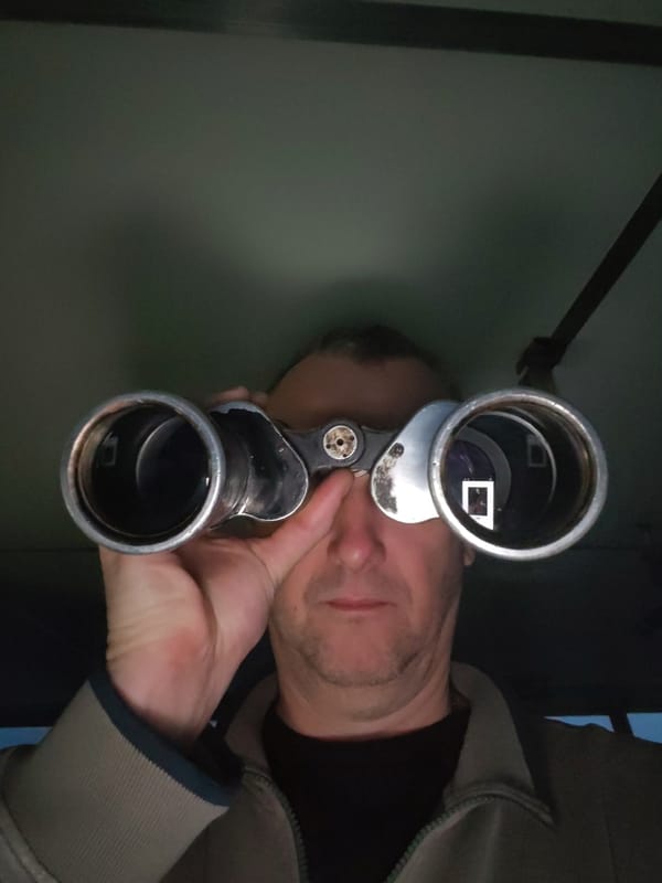 Man with binoculars observed near concrete dock in Bereg