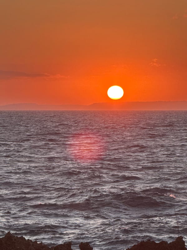 Sunset documented over ocean coastline in Kuta Selatan, Indonesia