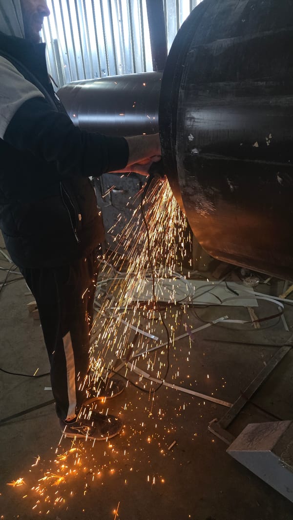 Worker performs metalworking operations at Bulgarian industrial workshop