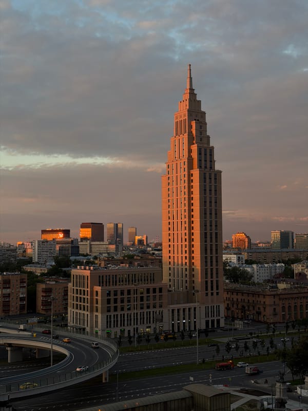 Moscow skyline at golden hour, brutalist towers and evening traffic