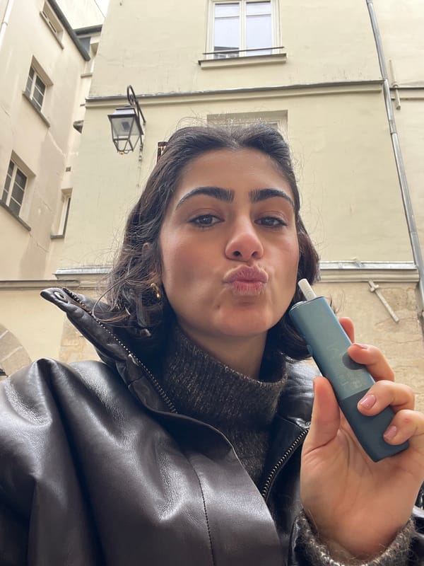 Woman takes selfies in Parisian courtyard near Le Temple