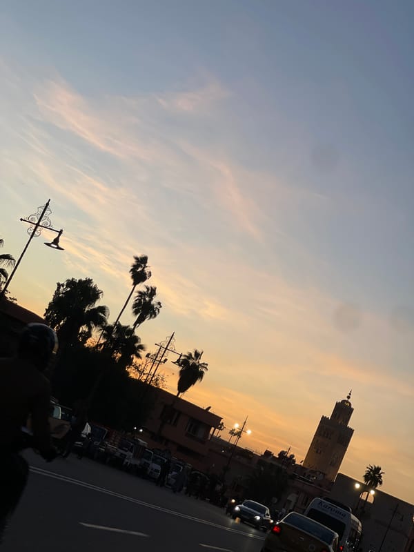 Evening traffic flows past Koutoubia Mosque during Marrakesh sunset