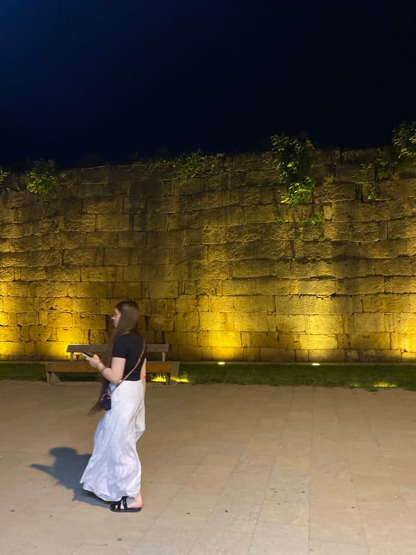 Evening crowd along Derbent's illuminated ancient fortress walls