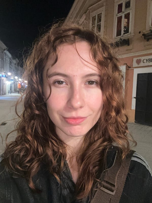 Woman takes nighttime selfies at Serbian National Theatre, Novi Sad