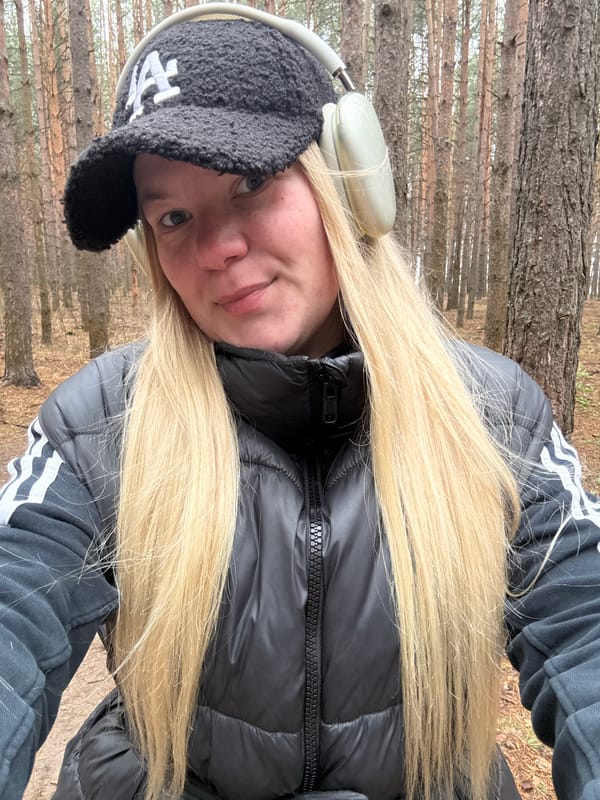 Woman takes selfies during morning walk in Chaikovsky forest