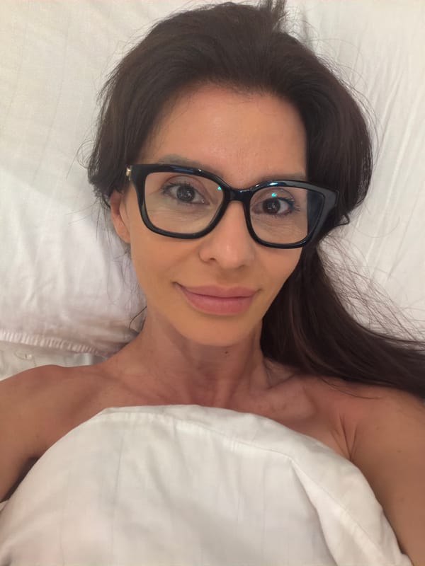 Woman rests in bed in Varna, Bulgaria bedroom